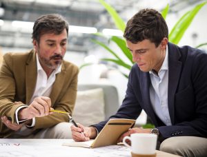 low angle male coworkers meeting office x