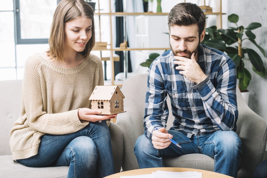 young couple thinking mortgage x