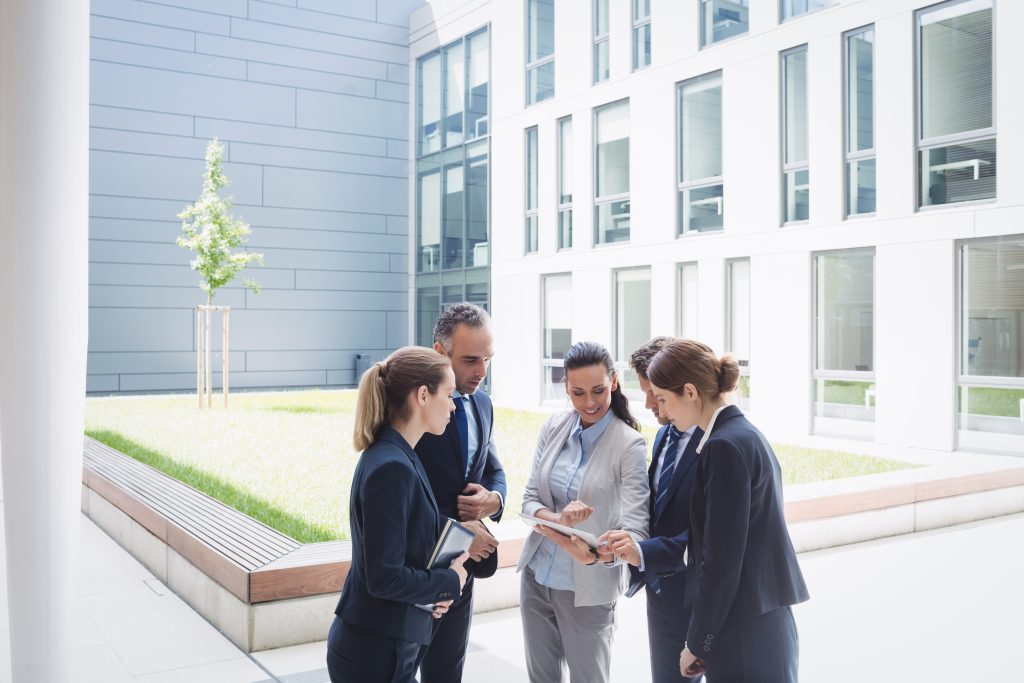 businesspeople discussing digital tablet x