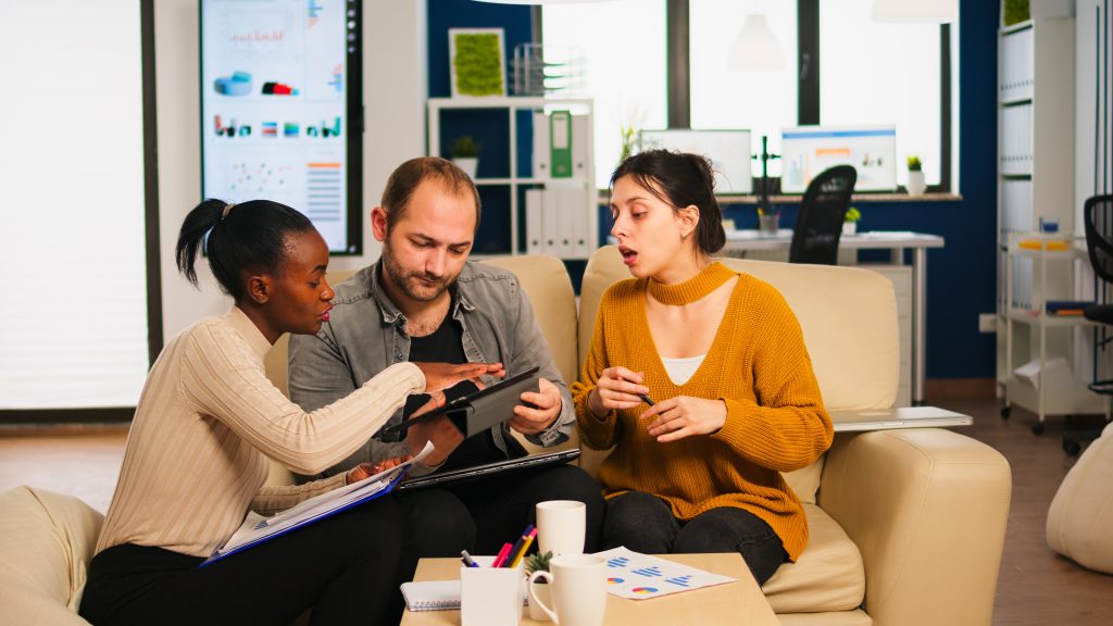 diverse businesspeople analysing financial project corporate meeting multiethnic employees group listening colleague sharing ideas discussing new marketing plan comparing data from tablet x
