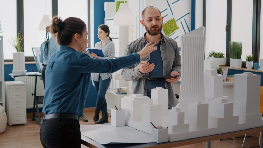 team coworkers analyzing maquette building model plan construction tablet architectural people working together designing urban strategy real estate development x